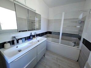 Enjoy a refreshing shower in the separate shower area with a glass enclosure.