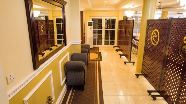 Welcome to our lobby, featuring a reception area, comfortable seating, and a decorative wall with a geometric design.