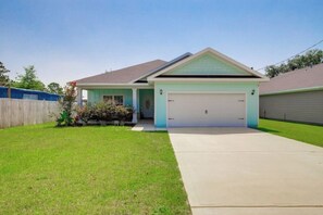 Stylish single-story home with a front porch and well-manicured lawn.