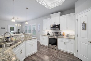 Enjoy cooking in this well-equipped kitchen with a microwave, oven, and sink.