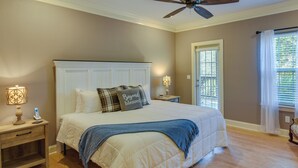 A bedroom with a bed, bedside tables, a ceiling fan, and a window with blinds. - Clayton Resort Getaway w/ Pool Access, Pickleball! (Clayton)
