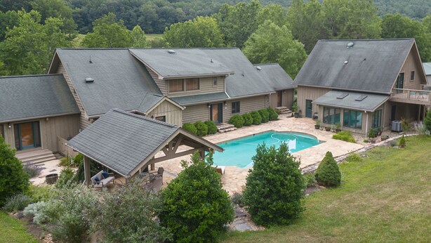 A residential area with multiple houses, a swimming pool, and a well-maintained garden. - Country living in a private setting, The Loft at Springhouse Farm (Rockbridge County)