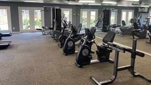 A gym with cardio machines, weight stations, and mirrors. - Cozy 1BR Apt in Medical Center. Close to Downtown/ Zoo/ Medical Center  (Houston)