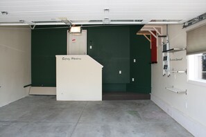 A compact space with a concrete floor, featuring a white door with the inscription 'Safety Matters' and a small window.