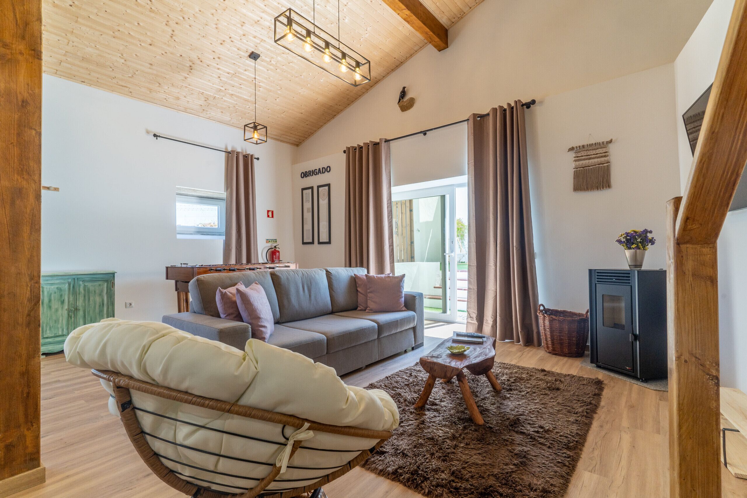 A cozy living room with a sofa, a chair, a coffee table, and a fireplace.