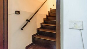 A staircase with a handrail and a light switch on the wall. - Via Duomo 196 - Studio Apartment, Sleeps 2 (Naples)
