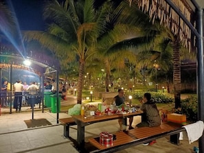 Dine al fresco amidst lush palm trees in our outdoor dining area.