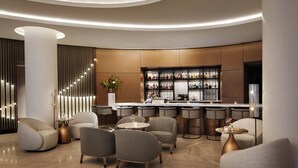 A modern bar area with a curved ceiling, bar stools, and a well-stocked liquor display. - InterContinental Seattle Bellevue, by IHG (Bellevue)