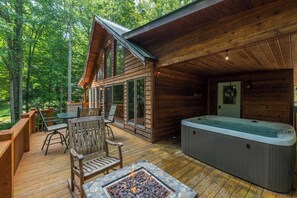 A wooden cabin with a deck, a hot tub, and a fire pit. - Mtn Ski Retreat | Hot Tub + Fire Pit + Fireplace (Mars Hill)