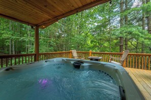 A hot tub on a wooden deck surrounded by trees. - Mtn Ski Retreat | Hot Tub + Fire Pit + Fireplace (Mars Hill)