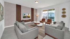 A modern living room with a grey sofa set, a coffee table, and a TV mounted on the wall. - Delight Kangaroo Home by All Vacation (Davenport)