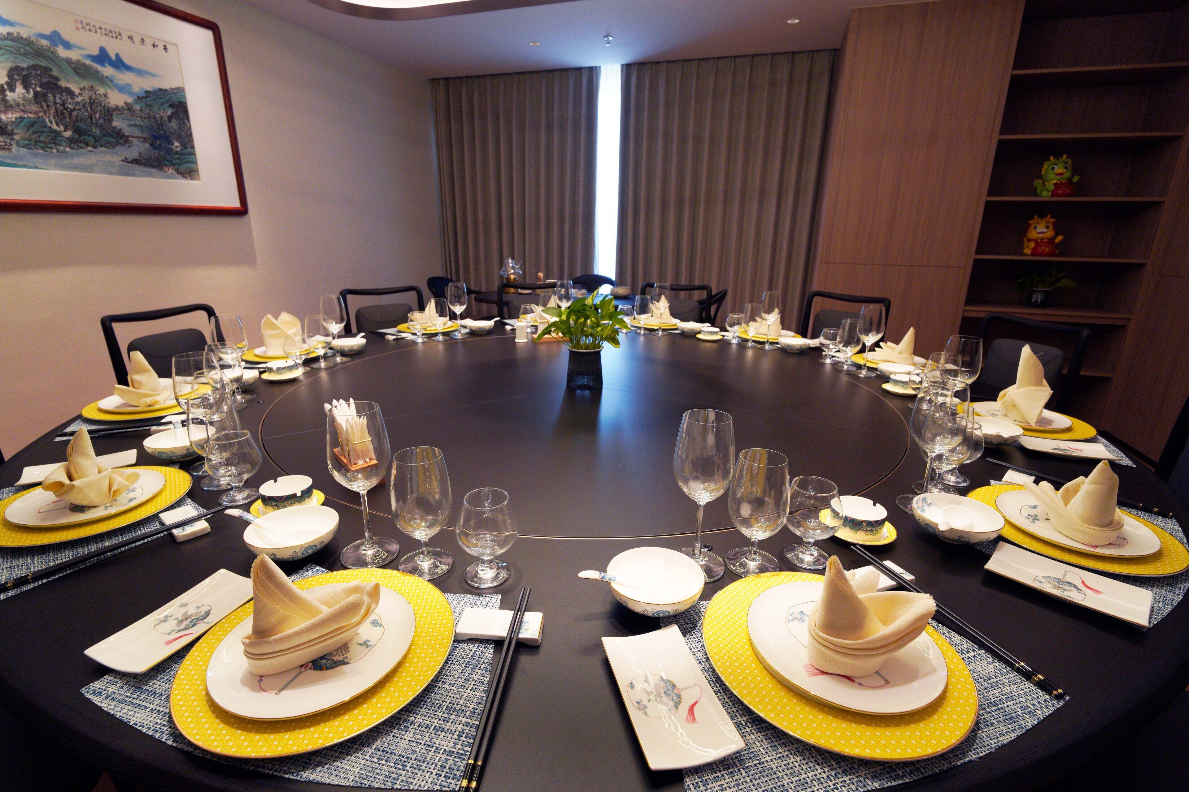 A conference room with a round table set for a meeting.