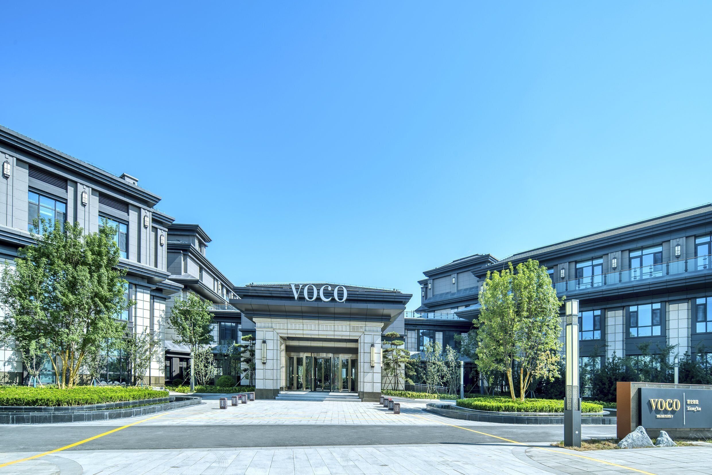 A modern building with a prominent entrance labeled 'VOCO'.