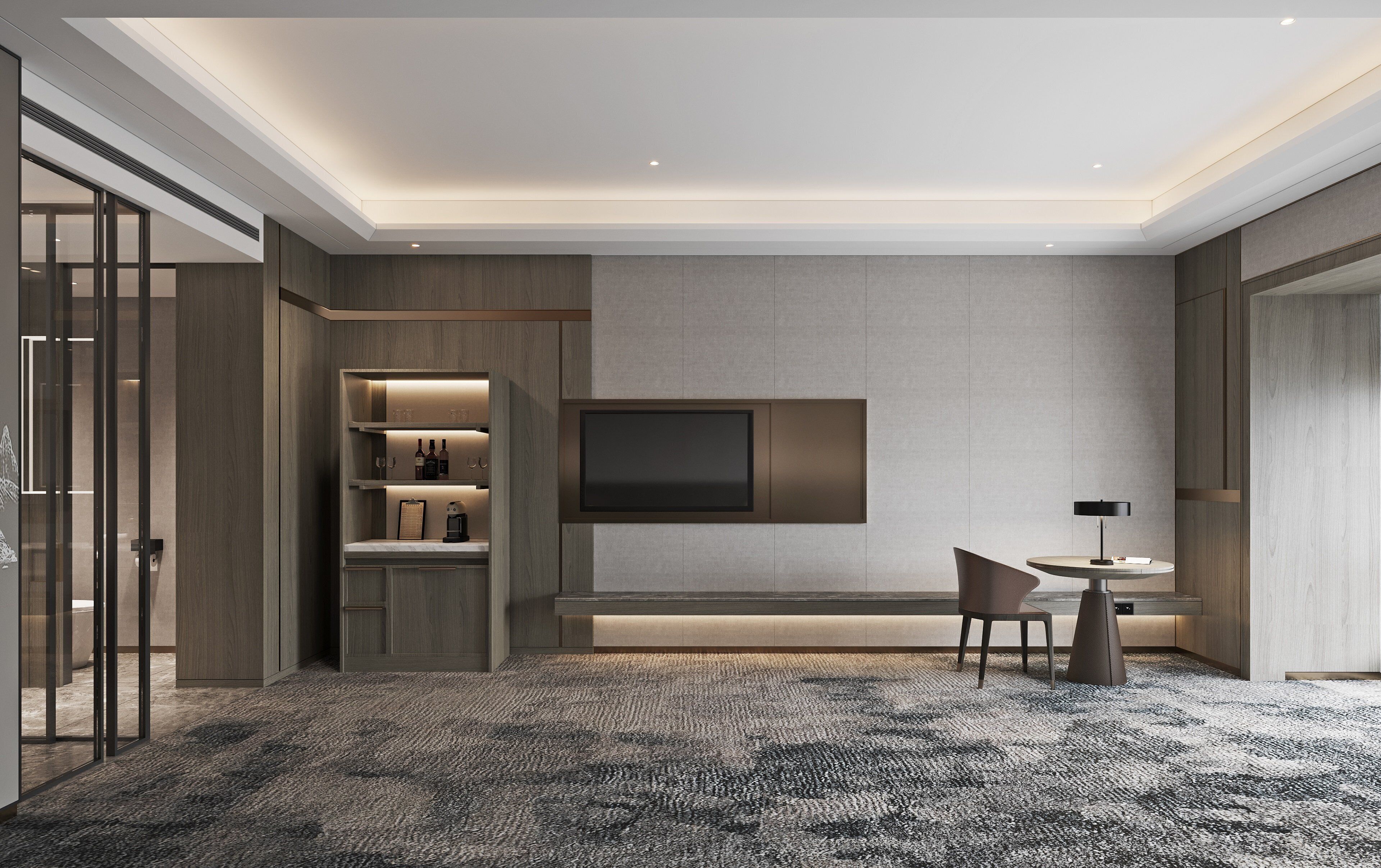 A modern hotel room with a large flat-screen TV mounted on the wall, a seating area with a table and chairs, and a built-in shelving unit with wine bottles and glasses.