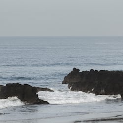 On the beach, black sand