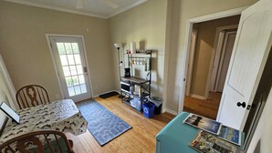 A compact kitchen with a dining table, chairs, a ceiling fan, and a refrigerator. - Phoenix Farms Vineyard (Edward)