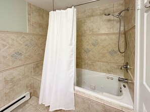 Bathtub, hair dryer, towels, soap