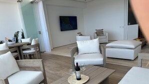 A modern living room with a wooden coffee table, white sofas, and a dining area with a wooden table and chairs. - Soho - PV
Luxury resort condo in heart of town with ocean & city view. (Puerto Vallarta)