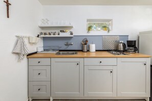 Fridge, stovetop, coffee/tea maker, cookware/dishes/utensils