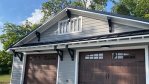 A two-car garage with a sloped roof and a small dormer window. - Recently updated Park Street Cottage with garage in Downtown Greeneville, TN. (Greeneville)
