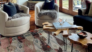 A spacious living room with a stone fireplace, large windows, and a cozy seating area. - HUGE VIEWS + LUX Finishes Outside Aspen (Basalt)