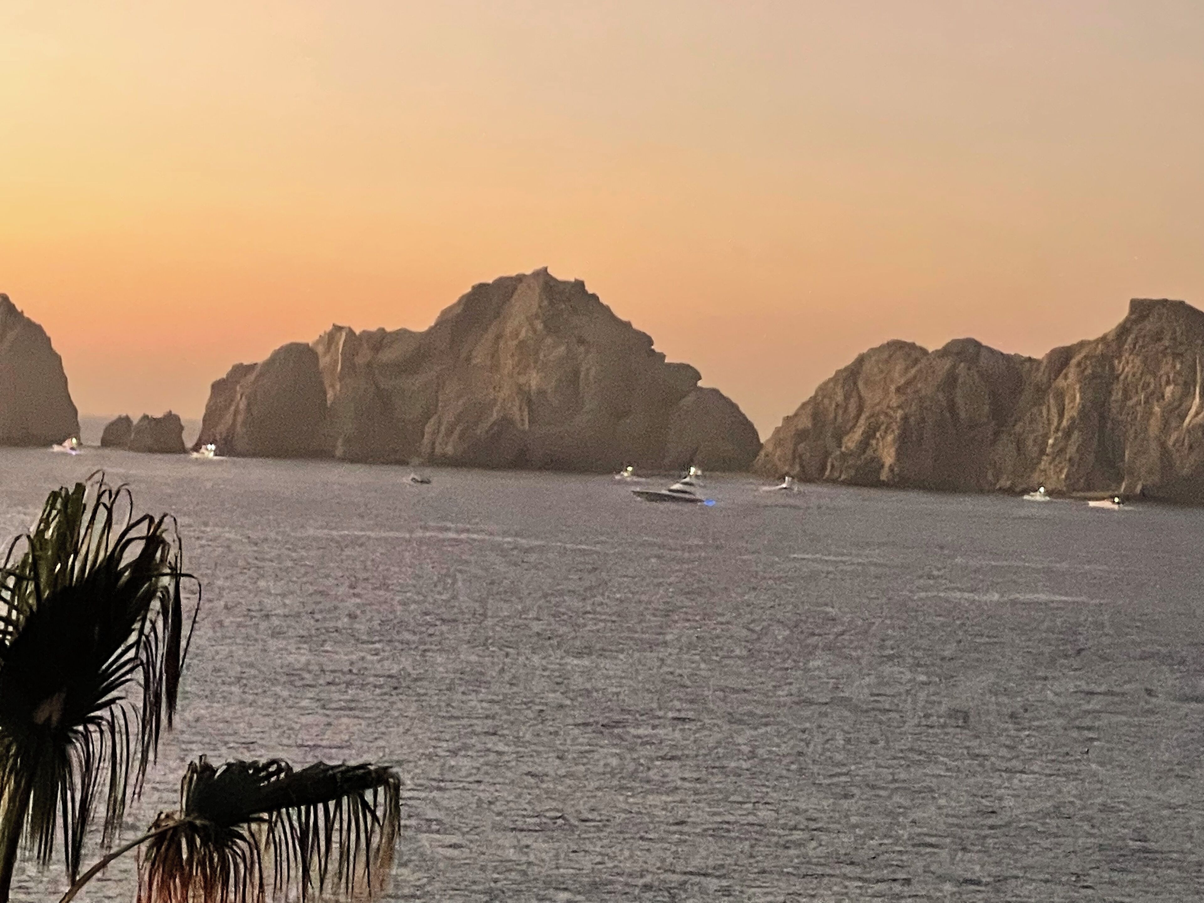 A coastal scene with rocky formations and calm waters.