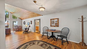 A spacious dining area with a wooden ceiling, a chandelier, and a view of the outdoors. - 4,000ft in Elevation with Layered Mtn Views, HOT TUB, Wifi, Firepit, and privacy (Waynesville)