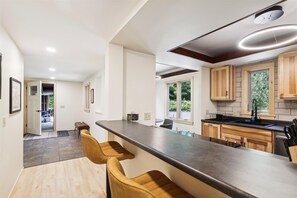 Enjoy cooking in this well-equipped kitchen with an oven and sink, and take in the view from the large window.