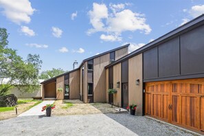 Stylish two-story home with a garage and lawn.