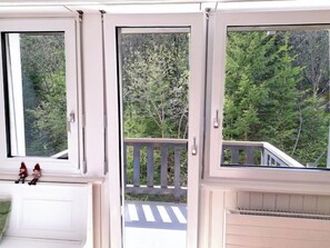 A balcony with a view of dense green trees. - Les Dauphinelles by Interhome (Thyon-Les Collons)
