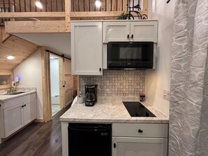 Fridge, microwave, coffee/tea maker, cookware/dishes/utensils