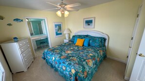 A bedroom with a bed, dresser, and ceiling fan. - Heart of Ocean Drive just one block to the Beach and Main Street  (North Myrtle Beach)