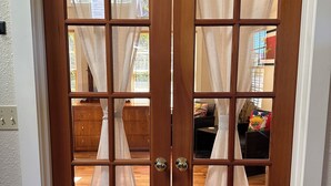 A wooden double door with glass panels and curtains. - Wonderfully located near Bay Street and all the wonderful restaurants. Sauna! (Florence)