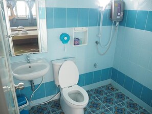 A bathroom with a toilet, sink, and shower. - Baan Bussara (Ayutthaya)