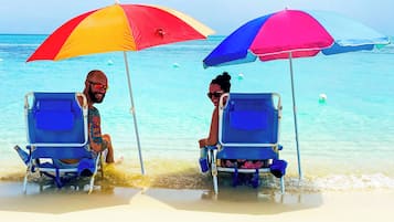 On the beach, white sand, sun-loungers, beach umbrellas