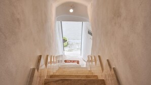 A staircase leading to a doorway with a view of a green outdoor area. - Biancostuni 44, The Little White Houses (Ostuni)