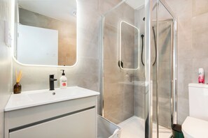 Shower, hair dryer, towels, shampoo
