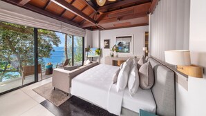 A bedroom with a large bed, a TV, and a view of the ocean. - Villa La Prana (Kamala)