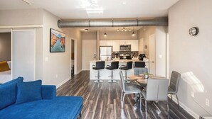 A modern apartment with a living room, dining area, and kitchen. - Charming 1,100 sq. ft. apt (Plano)