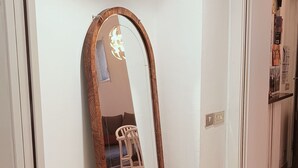 A room with a large mirror, a drying rack with a towel, a white shelf unit, and a chair. - Chinatown-Sarpi 1860 Apt w/Elevator. Walk to Duomo & Brera. Easy to San Siro (Milano)