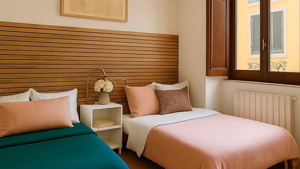 A bedroom with two beds, a wooden headboard, a bedside table with a vase, and a window with shutters. - Chinatown-Sarpi 1860 Apt w/Elevator. Walk to Duomo & Brera. Easy to San Siro (Milano)