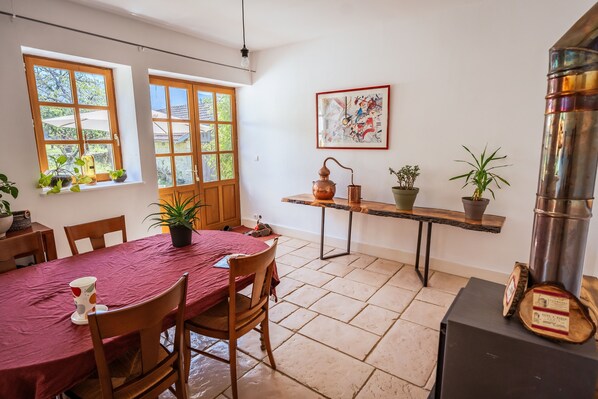 Enjoy meals in this dining area with a table for four, surrounded by lush views and decorative touches.