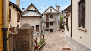 A narrow cobblestone street flanked by buildings with balconies and windows. - Apartment "Casa del Sole" with Mountain View & Wi-Fi (Toceno)