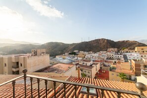 A town with terracotta-roofed buildings, a mountainous backdrop, and a clear sky. - Vacation Apartment "Mccoy Avenida 3" with 2 Balconies and Shared Terrace (Macael)