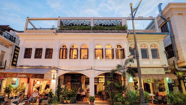 A two-story building with a ground-floor cafe and upper-floor shops. - Atelier Hotel (Siem Reap)
