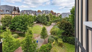 A residential area with traditional houses, a well-maintained garden, and a clear sky. - Le Clos Mathilde by Interhome (Cabourg)