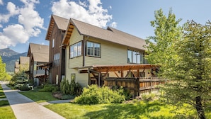 A two-story house with a wooden exterior and a covered porch. - Town Center | Hot Tub | Ski Shuttle (Big Sky)