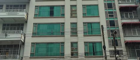 A multi-story hotel with a sign indicating it is now open.