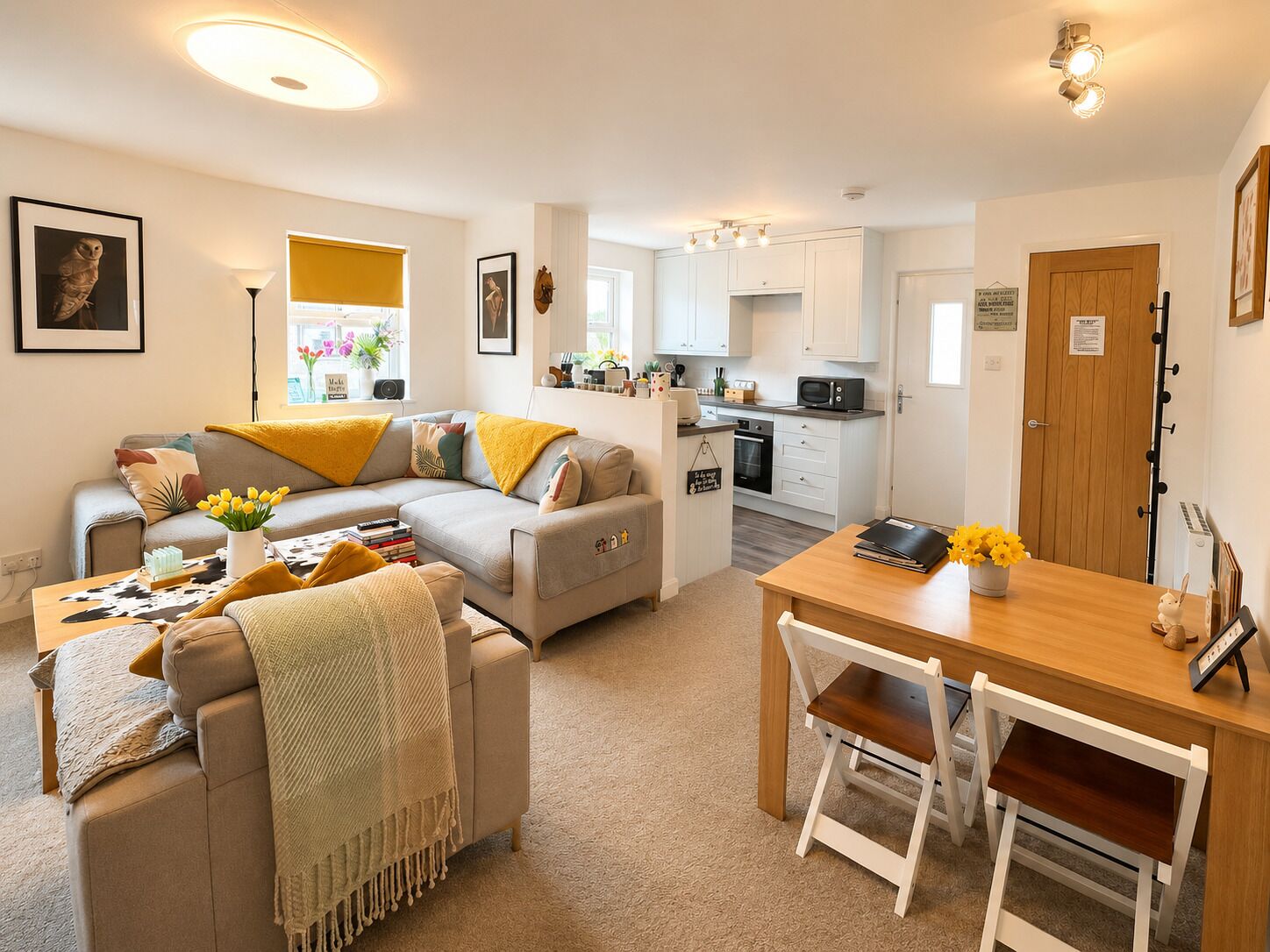 A modern apartment with a living room, dining area, and kitchen.