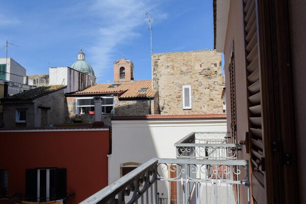 A view of a building with a bell tower and a dome, a stone wall, and a metal railing. - Marechiare Intera in Ortona (Ortona)